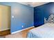 Comfortable bedroom featuring blue painted walls and access to an adjacent room at 260 Brookwood Ln, Fayetteville, GA 30215