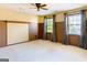 Spacious bedroom features carpet, two windows, and neutral paint, offering a cozy ambiance at 260 Brookwood Ln, Fayetteville, GA 30215