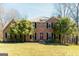 Two-story brick home featuring a lush front lawn and mature trees at 260 Brookwood Ln, Fayetteville, GA 30215