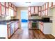 Well-lit kitchen with stainless steel appliances, granite countertops, and wood floors at 260 Brookwood Ln, Fayetteville, GA 30215