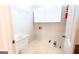 Functional laundry room featuring overhead cabinets, sink, and easy access to utilities at 260 Brookwood Ln, Fayetteville, GA 30215