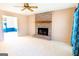 Cozy living room featuring a classic brick fireplace and neutral carpet at 260 Brookwood Ln, Fayetteville, GA 30215