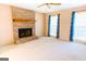 Carpeted living room with a brick fireplace, ceiling fan, and natural light at 260 Brookwood Ln, Fayetteville, GA 30215