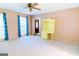 Bright, carpeted living room with a ceiling fan and cheerful yellow shelving at 260 Brookwood Ln, Fayetteville, GA 30215