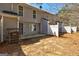 Gray-sided home shows the backyard with its concrete patio and white fence at 3911 Waldrop Ln, Decatur, GA 30034