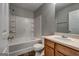 Bathroom featuring vanity, toilet, and bathtub with tiled surround at 3911 Waldrop Ln, Decatur, GA 30034