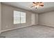 Spacious bedroom with neutral walls, ceiling fan and carpet, enhanced by natural light from the window at 3911 Waldrop Ln, Decatur, GA 30034