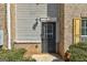 Close up of front door featuring brick and vinyl siding and manicured shrubs at 3911 Waldrop Ln, Decatur, GA 30034