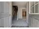 Welcoming foyer with carpeted stairs and luxury vinyl flooring, offering a bright and open feel at 3911 Waldrop Ln, Decatur, GA 30034