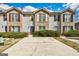 Inviting townhouse with brick and siding, features a concrete parking pad and well-maintained landscaping at 3911 Waldrop Ln, Decatur, GA 30034