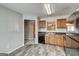 Modern kitchen with light wood cabinets, black appliances, gray backsplash and wood-look floors at 3911 Waldrop Ln, Decatur, GA 30034