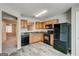 Well-lit kitchen featuring stainless steel appliances, light wood cabinets, and durable flooring at 3911 Waldrop Ln, Decatur, GA 30034