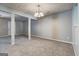 Spacious living room with gray carpet, textured ceilings, and a classic chandelier at 3911 Waldrop Ln, Decatur, GA 30034