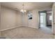 Bright living room area with neutral gray walls, plush carpeting, and stylish lighting fixture at 3911 Waldrop Ln, Decatur, GA 30034