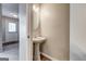 Charming powder room featuring pedestal sink and modern wood-look floors at 3911 Waldrop Ln, Decatur, GA 30034