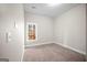 Carpeted bedroom featuring a window view of the home's outdoor scenery at 4866 Pinnacle Dr, Stone Mountain, GA 30088