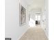 Spacious hallway with neutral carpeting and artwork, leading to bedrooms and bathrooms at 337 Skylar Se Way, Atlanta, GA 30315