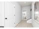 Bright hallway with neutral tones and natural light filtering in from the adjacent bedroom at 337 Skylar Se Way, Atlanta, GA 30315
