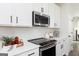 Well-lit kitchen featuring white cabinets, modern appliances, and sleek black hardware at 337 Skylar Se Way, Atlanta, GA 30315