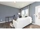 Cozy living room featuring a white couch, stylish gray accent wall and modern decor at 337 Skylar Se Way, Atlanta, GA 30315