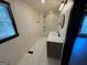 Bright bathroom featuring a tub/shower combo and a modern single sink vanity at 1 Maple St, Porterdale, GA 30014