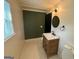 Well-lit bathroom featuring a modern vanity with updated mirror, lighting, and fixtures at 1 Maple St, Porterdale, GA 30014