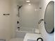 The bathroom boasts a sleek shower/tub combo, updated vanity and fixtures at 1 Maple St, Porterdale, GA 30014