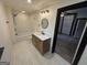 Bathroom with shower/tub combo, modern vanity, and tile flooring at 1 Maple St, Porterdale, GA 30014