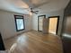 Bedroom with light-colored wood floors, ceiling fan and large windows for natural light at 1 Maple St, Porterdale, GA 30014