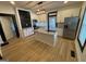 Modern kitchen with stainless steel appliances, granite countertops, a center island and wood look flooring at 1 Maple St, Porterdale, GA 30014