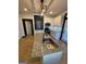 Well-lit kitchen features stainless appliances, granite counters, a center island with sink and tile backsplash at 1 Maple St, Porterdale, GA 30014