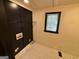Laundry room with black accent wall, shelving, and a window for natural light at 1 Maple St, Porterdale, GA 30014