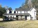 Traditional two-story home with stone porch, dormer windows and mature landscaping at 1273 Baywood Gln, Lithonia, GA 30058