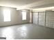 Spacious two car garage with painted floor and two windows offering ample natural light at 1273 Baywood Gln, Lithonia, GA 30058