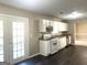 Bright kitchen featuring white cabinetry, granite countertops, and stainless steel appliances with views to the backyard at 1273 Baywood Gln, Lithonia, GA 30058
