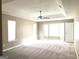 Spacious primary bedroom with tray ceilings, carpeted floors, a ceiling fan and plenty of natural light at 1273 Baywood Gln, Lithonia, GA 30058