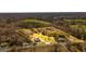 Aerial view shows home, grassy fields, trees, other homes and boundary lines of the properties at 721 Wedowee St, Bowdon, GA 30108