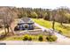 Aerial view of a charming home with a picturesque yard, long driveway, and inviting landscaping at 721 Wedowee St, Bowdon, GA 30108