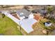 Aerial view of a newly renovated home with a gravel driveway and well-maintained yard at 721 Wedowee St, Bowdon, GA 30108