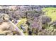 Aerial view showing bright two-story home with its tree-surrounded neighborhood on a sunny day at 721 Wedowee St, Bowdon, GA 30108