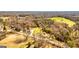 Aerial view shows the bright two-story home surrounded by grassy fields and woods at 721 Wedowee St, Bowdon, GA 30108