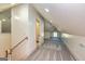 Attic space with stairway, a window, and view to a bathroom at 721 Wedowee St, Bowdon, GA 30108