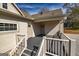 Cozy back porch with gray decking, white railing, and convenient access doors and windows at 721 Wedowee St, Bowdon, GA 30108