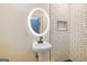 Bright bathroom features modern subway tile, lighted round mirror, and pedestal sink at 721 Wedowee St, Bowdon, GA 30108