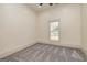 Light filled bedroom with plush carpet and a large window overlooking the yard at 721 Wedowee St, Bowdon, GA 30108