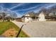 Home exterior with gravel driveway, manicured lawn, and covered porch with white railing at 721 Wedowee St, Bowdon, GA 30108