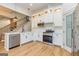 Modern kitchen boasting stainless appliances, white cabinetry, and quartz countertops at 721 Wedowee St, Bowdon, GA 30108