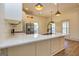 Spacious kitchen island with quartz countertops, stainless appliances and breakfast bar at 721 Wedowee St, Bowdon, GA 30108