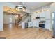 Bright kitchen features white cabinets, stainless appliances, and an open layout with hardwood flooring at 721 Wedowee St, Bowdon, GA 30108
