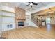 Elegant living space with a brick fireplace, coffered ceiling, hardwood floors, and seamless flow to the kitchen at 721 Wedowee St, Bowdon, GA 30108